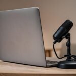 Best cheap microphones for online meetings and remote jobs showing an affordable USB microphone on a desk with laptop